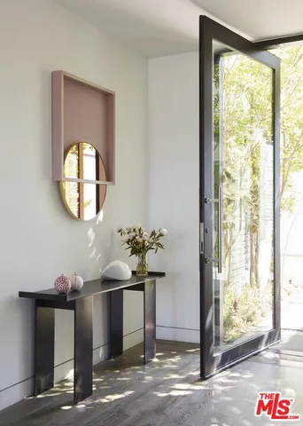 a front view of a house with wooden floor and a window