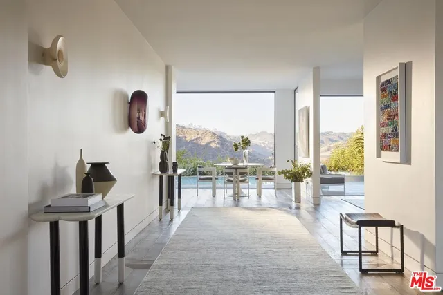 a living room with furniture and a floor to ceiling window