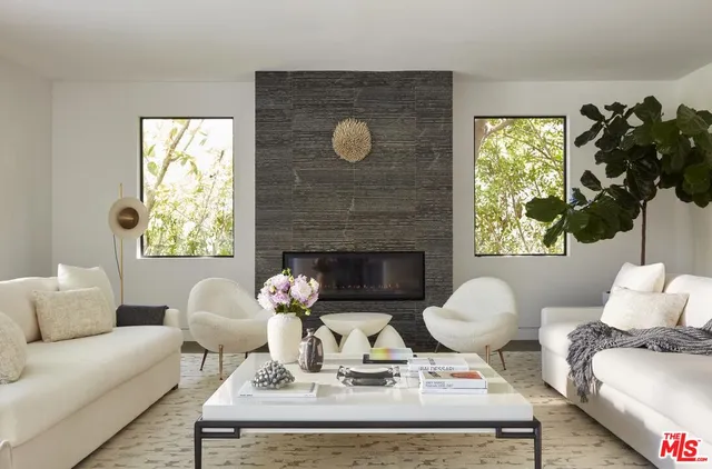 a living room with furniture a window and a fireplace