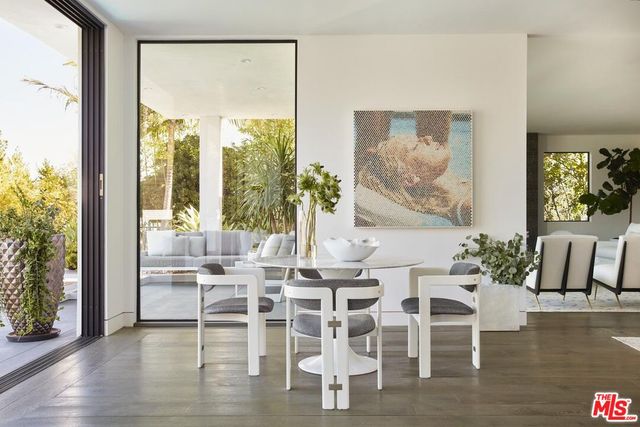 a dining room with furniture a chandelier and wooden floor