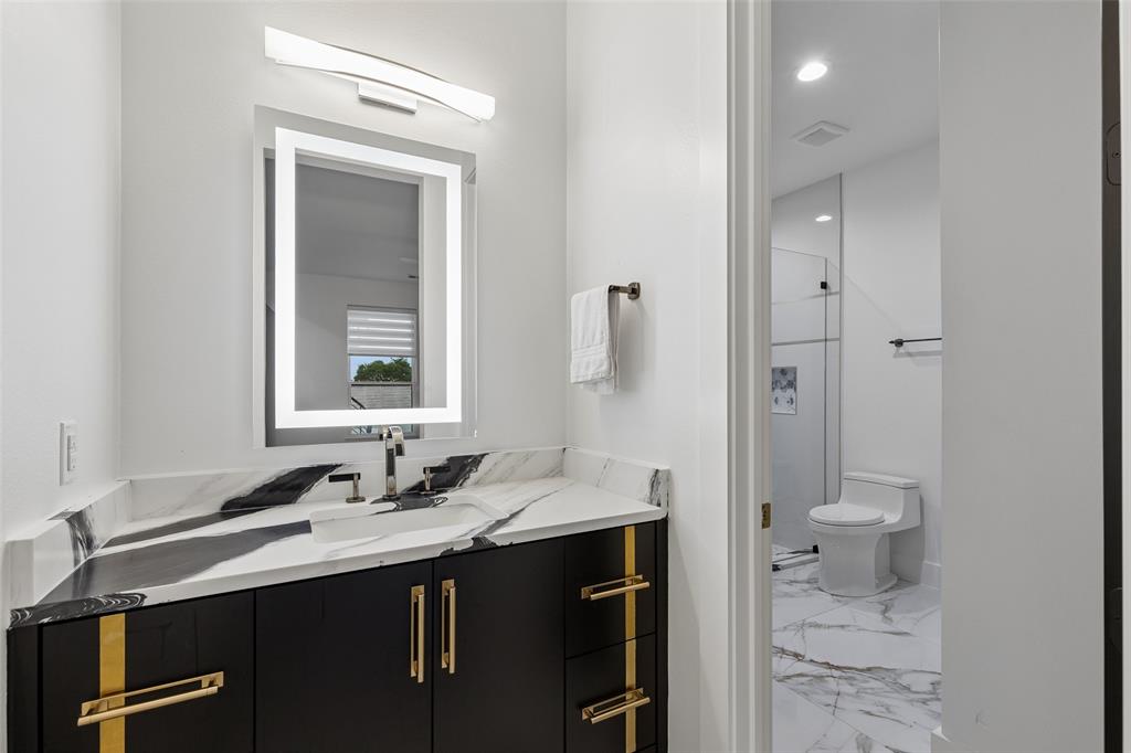 1053 Sedalia Road Van Alstyne, TX 75495 - Photo 16 of 40 a bathroom with a sink a toilet and shower