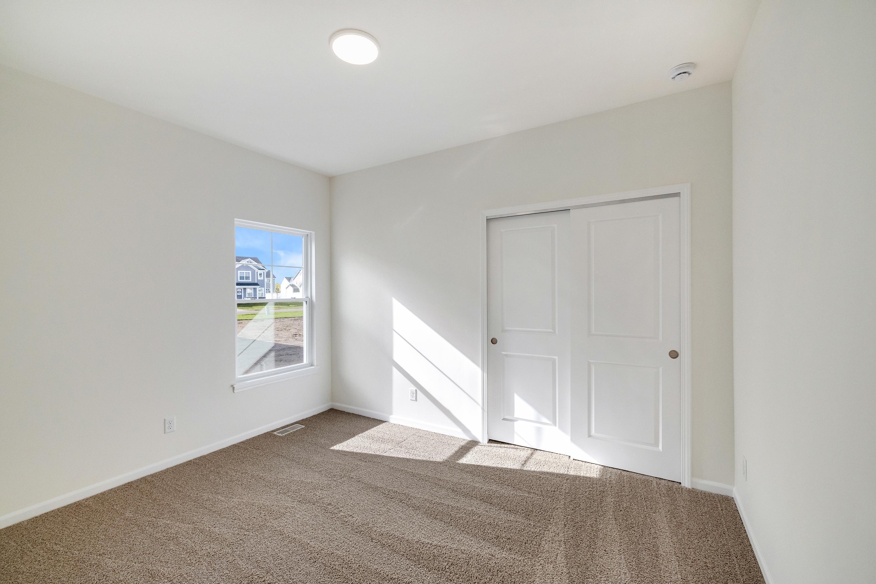 13070 Carolina Street Crown Point, IN 46307 - Photo 6 of 18 an empty room with wooden floor and windows