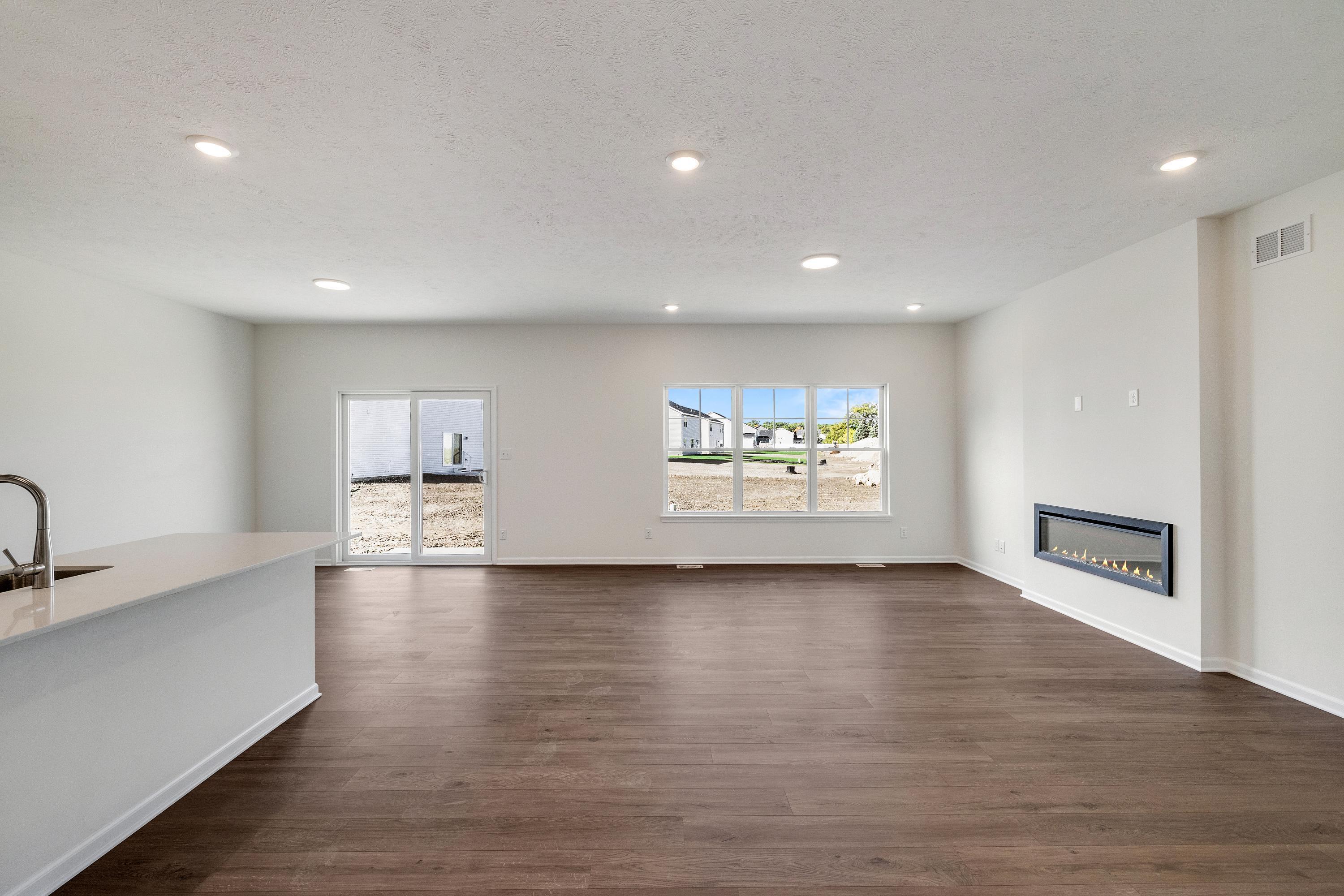 13070 Carolina Street Crown Point, IN 46307 - Photo 7 of 18 a view of empty room with wooden floor and fireplace