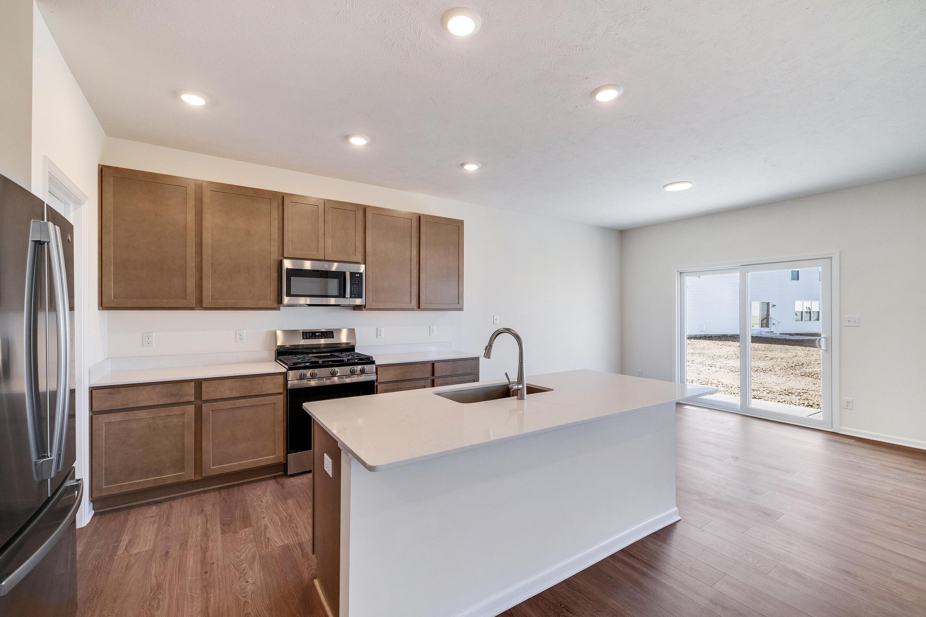 13070 Carolina Street Crown Point, IN 46307 - Photo 8 of 18 a kitchen with stainless steel appliances granite countertop a sink stove and refrigerator
