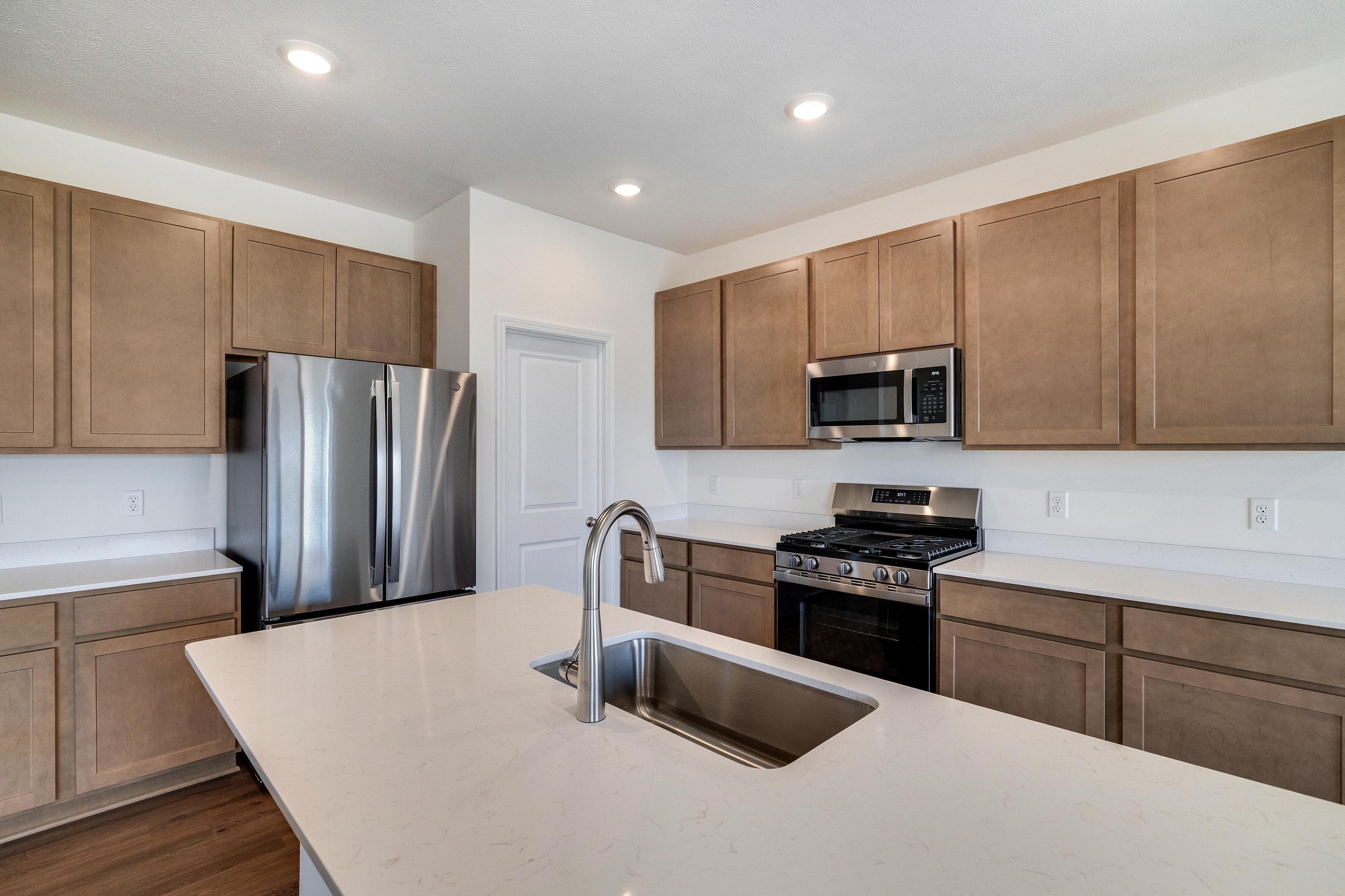 13070 Carolina Street Crown Point, IN 46307 - Photo 9 of 18 a kitchen with stainless steel appliances a refrigerator stove microwave and sink