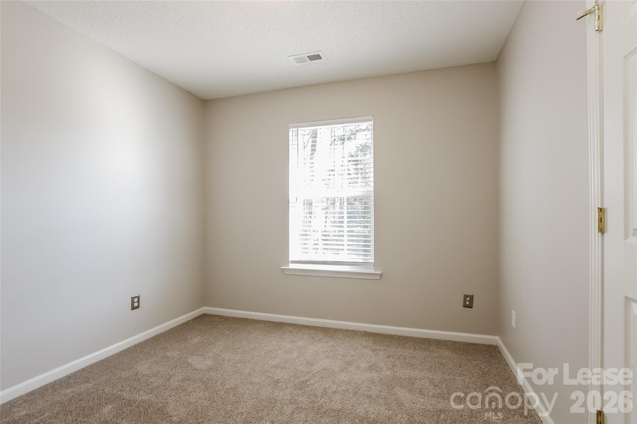 10802 Gold Pan Road Charlotte, NC 28215 - Photo 10 of 15 an empty room with a window