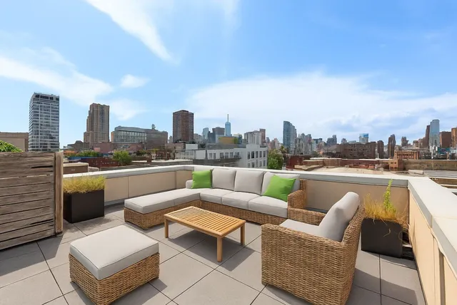 a living room with a couch and a book shelf