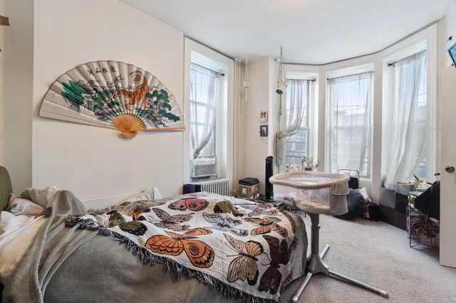 a bedroom with bed and a window