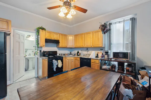 a kitchen with stainless steel appliances granite countertop a refrigerator a stove top oven a sink dishwasher and white cabinets with wooden floor