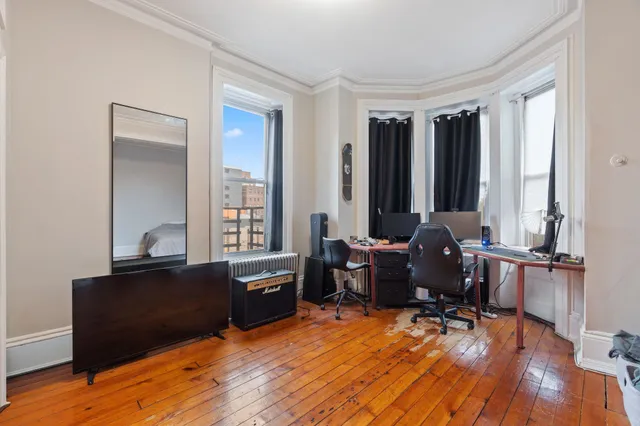 a living room with furniture and wooden floor