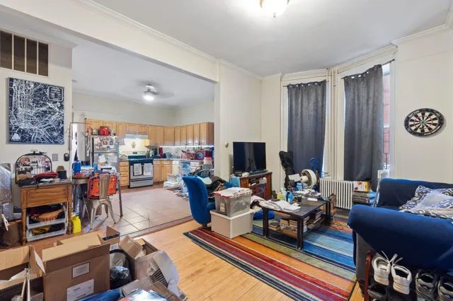 a living room with furniture a rug and a window