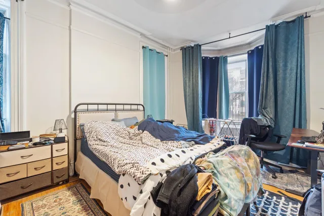 a bedroom with a bed and a window