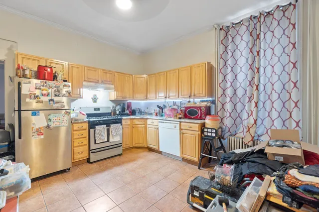 a kitchen with a refrigerator and a stove