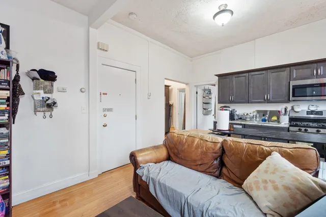 a living room with furniture and a kitchen