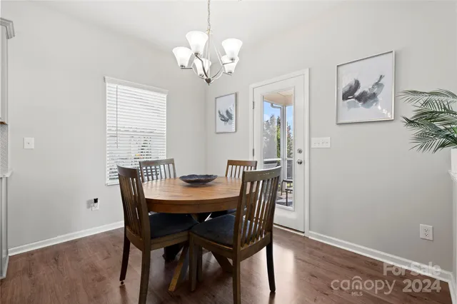 a view of a dining room with furniture wooden floor and a chandelier