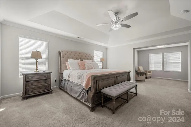 a spacious bedroom with a bed and window