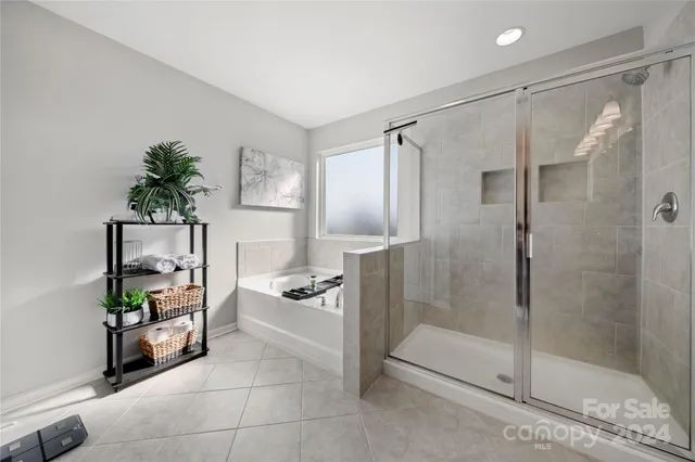 a bathroom with a shower and a sink a mirror