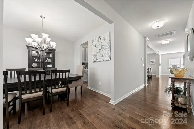 a view of a dining room with furniture wooden floor and a chandelier