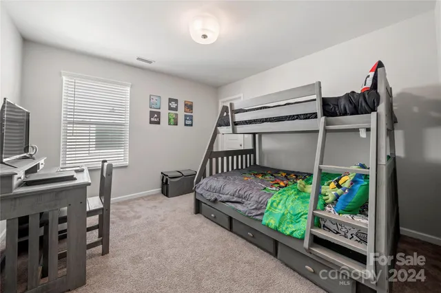 a bedroom with bed and a window