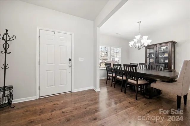 a view of a dining room with furniture and chandelier