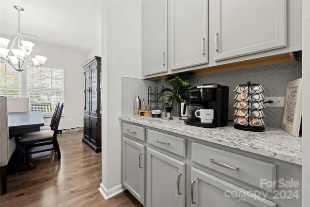 a kitchen with stainless steel appliances granite countertop a sink dishwasher and cabinets with wooden floor