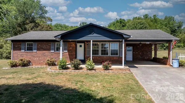 a front view of a house with a yard outdoor seating and barbeque oven
