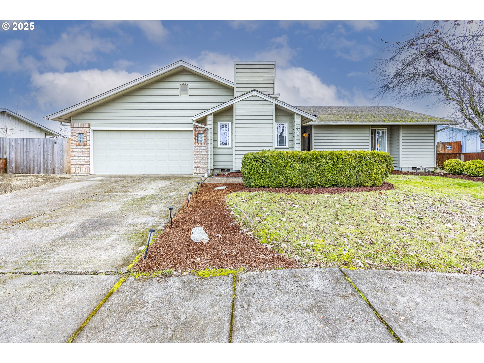 175 North 49th Street Springfield, OR 97478 - Photo 1 of 37 a front view of a house with a yard and garage