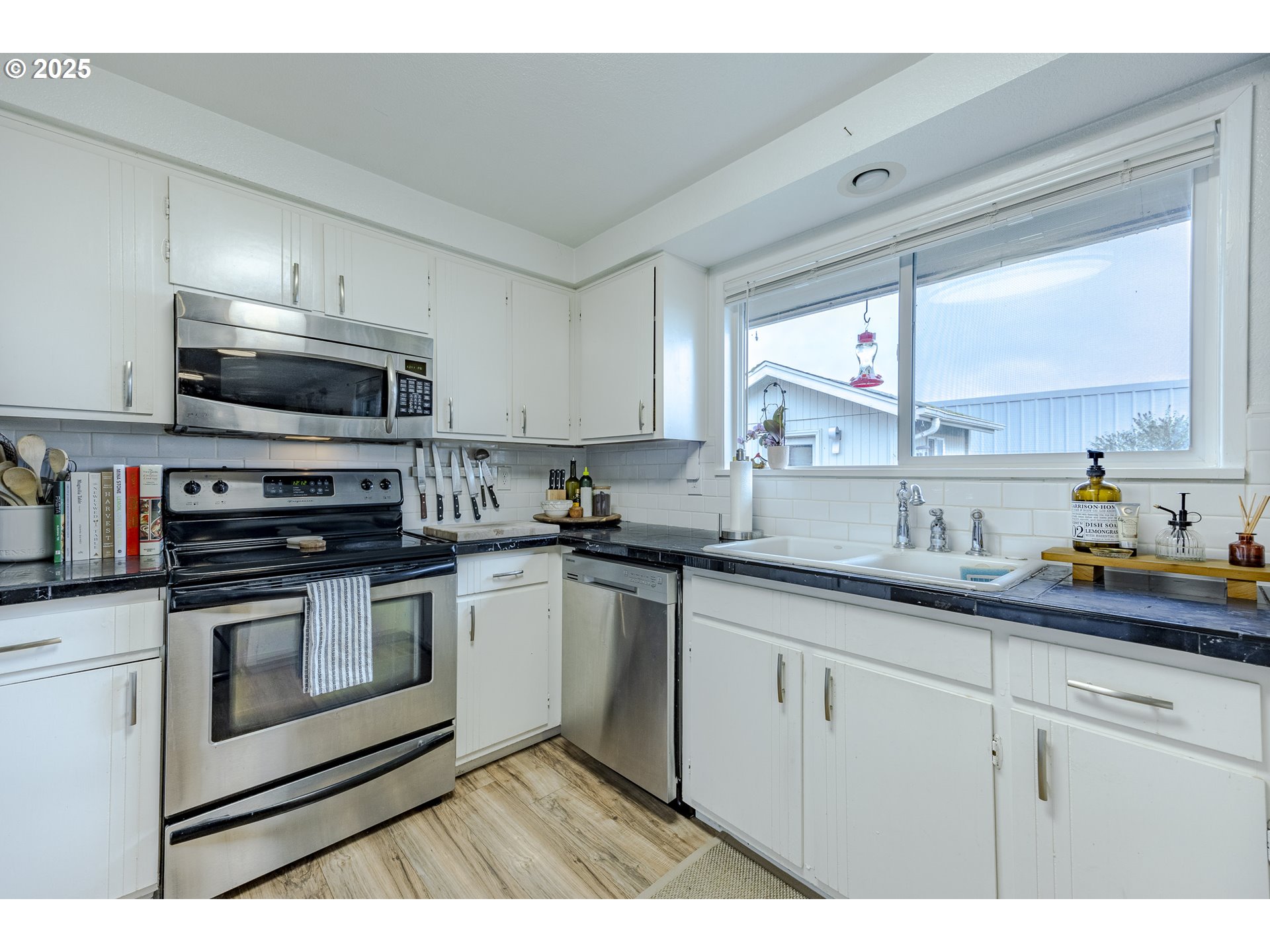 175 North 49th Street Springfield, OR 97478 - Photo 15 of 37 a kitchen with granite countertop a sink stainless steel appliances and cabinets