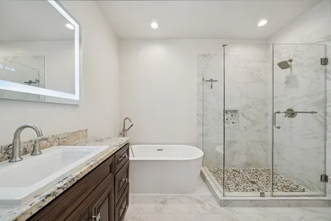 an empty room with wooden floor and a hallway