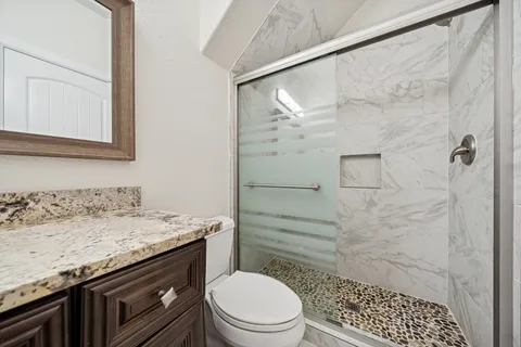 a bedroom with a large bed and a tv on the dresser