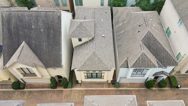 a view of a house with a large window and wooden fence
