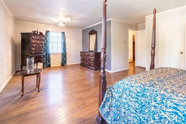 a bedroom with furniture and a wooden floor