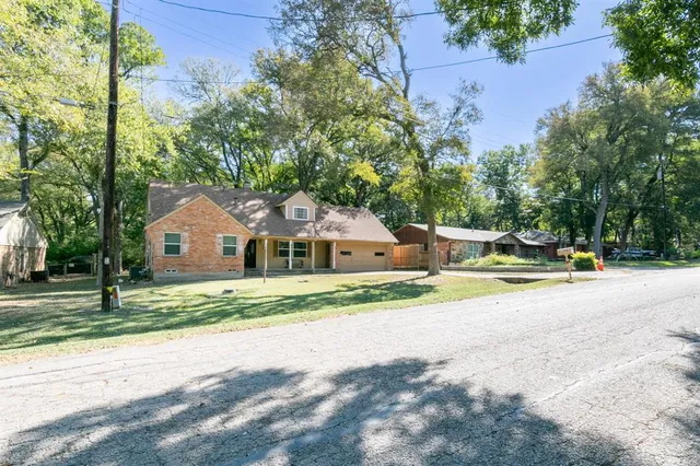 a house with a yard and a large tree