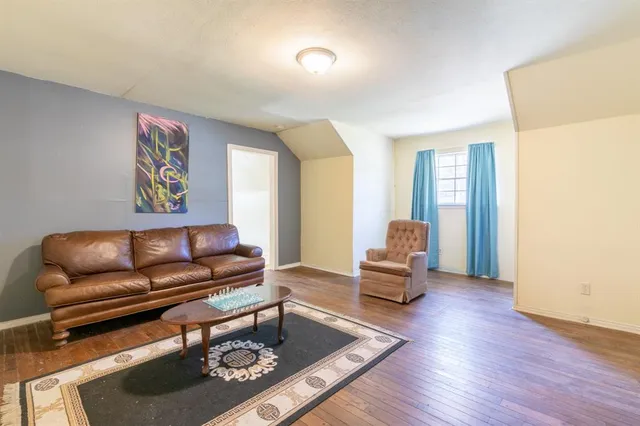 a living room with furniture and a lamp