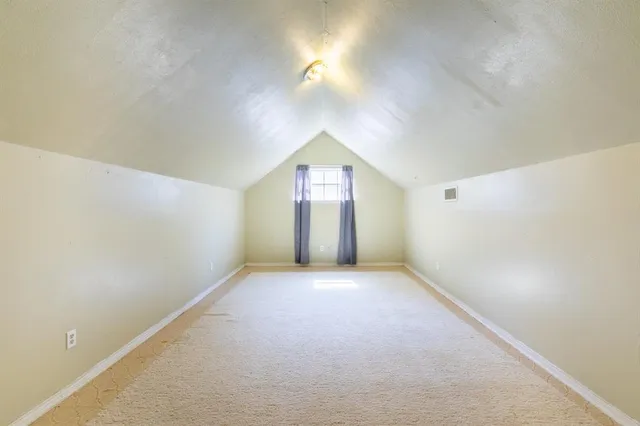 an empty room with windows and painted walls