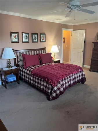 a bedroom with a bed rug and window