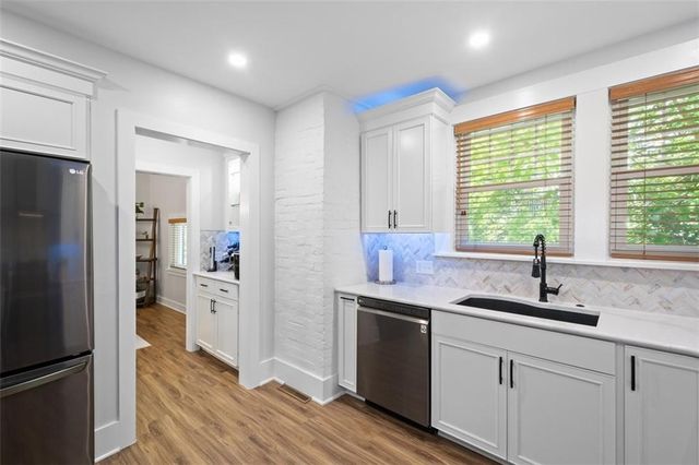 a kitchen with stainless steel appliances granite countertop a refrigerator and a sink