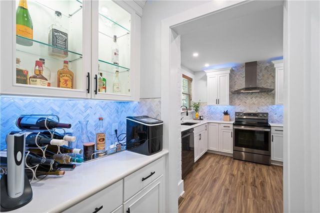 a kitchen with a sink a stove and cabinets