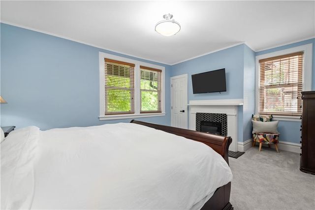 a spacious bedroom with a bed and a flat screen tv