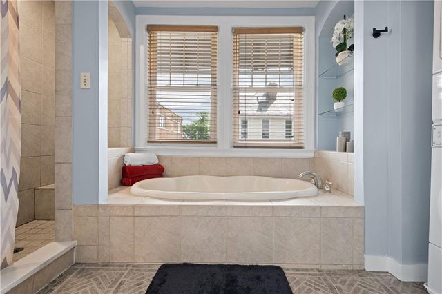 a white bath tub sitting next to a window