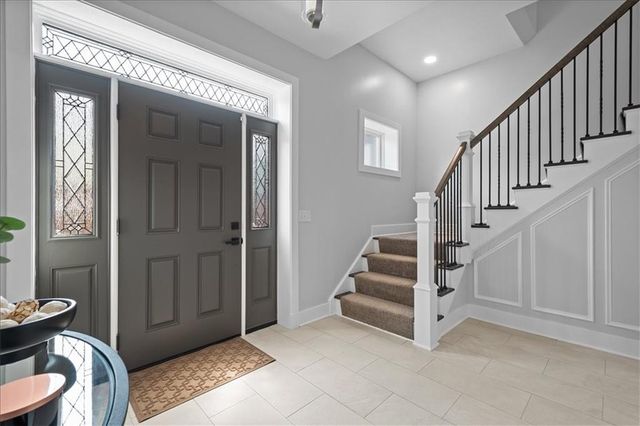 a view of entryway with stairs and wooden floor
