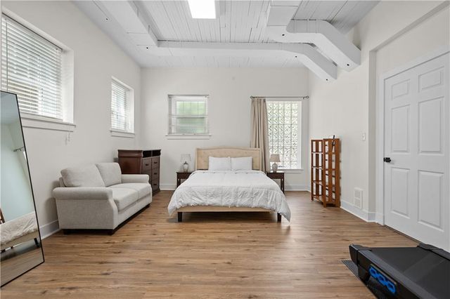 a spacious bedroom with a bed and furniture
