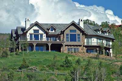 310 Little Andorra Road Edwards, CO 81632 - Photo 1 of 7 a view of a big house with a big yard and large trees