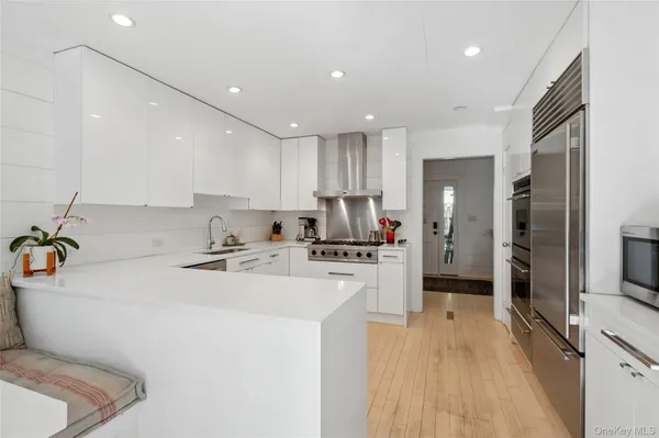 a kitchen with a sink a stove cabinets and refrigerator