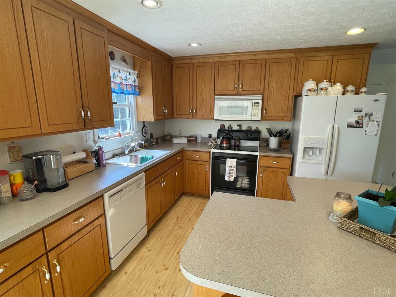755 Bearfield Road Amherst, VA 24521 - Photo 34 of 98 a kitchen with a sink a refrigerator and cabinets