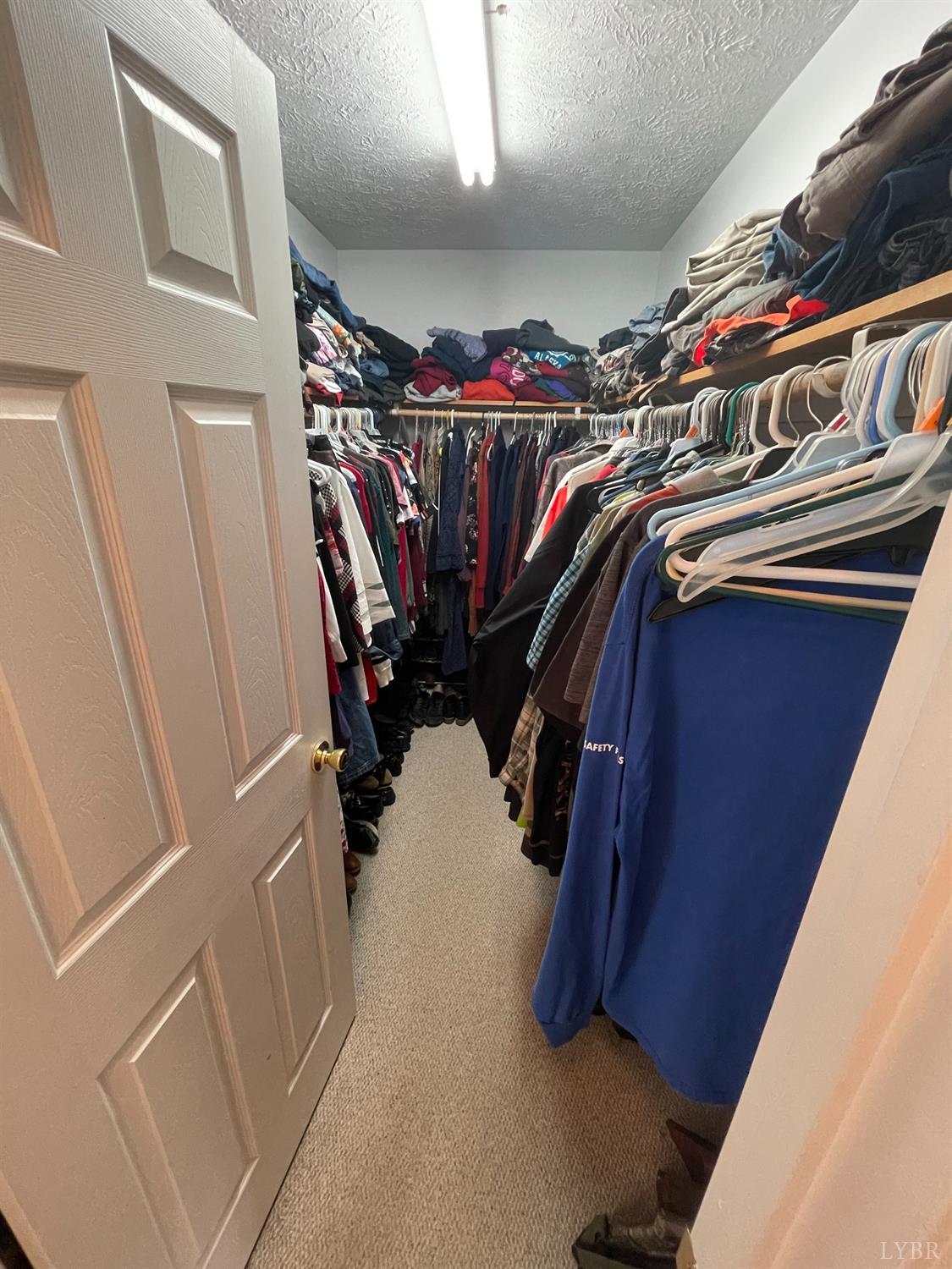 755 Bearfield Road Amherst, VA 24521 - Photo 51 of 98 a view of walk in closet with clothes and shoes
