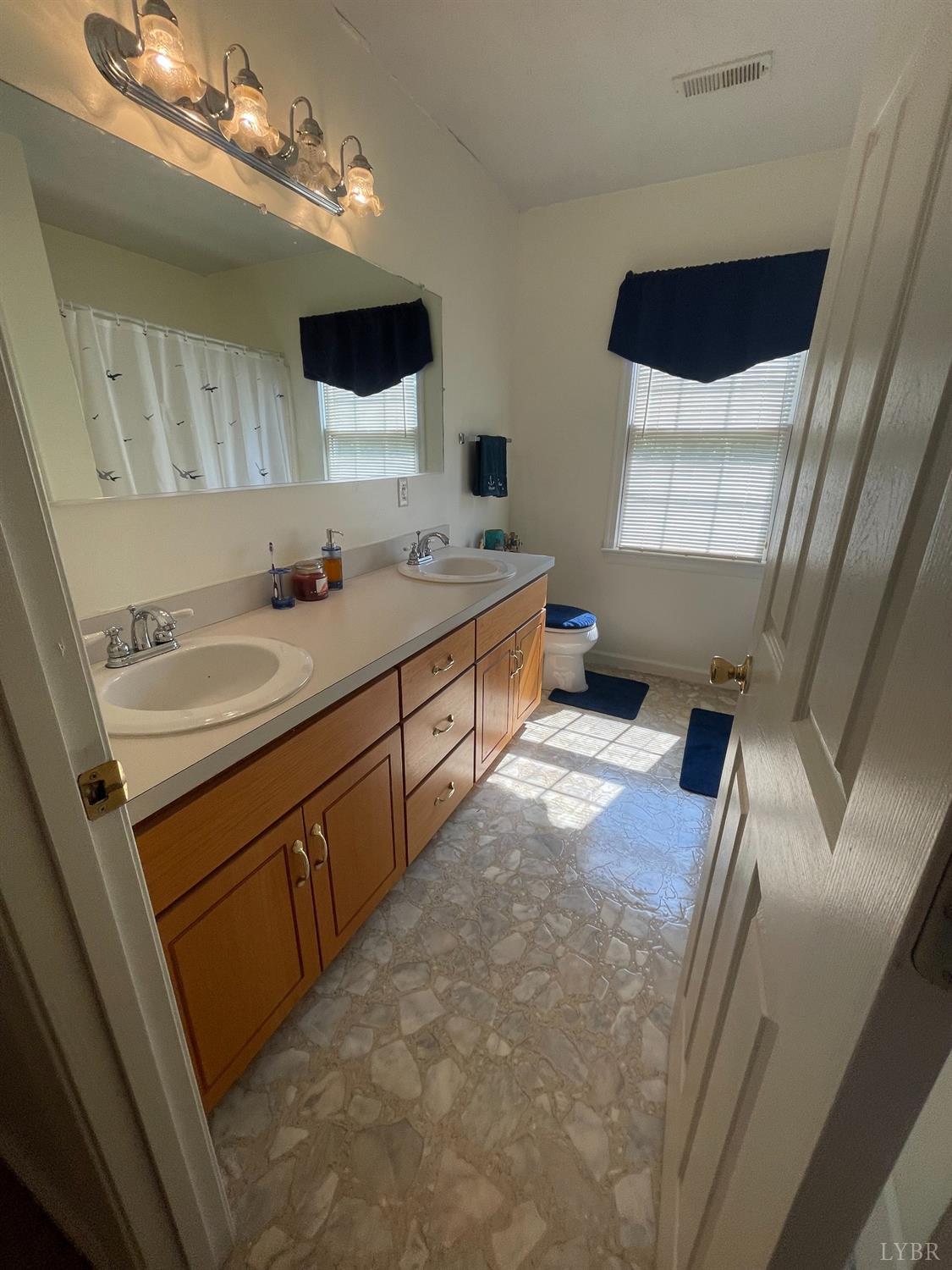 755 Bearfield Road Amherst, VA 24521 - Photo 63 of 98 a bathroom with a double vanity sink and mirror