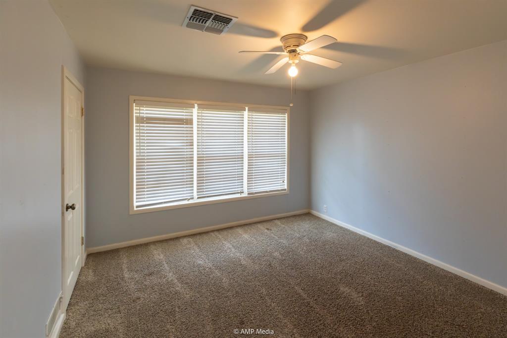 451 Northwest Ave F Hamlin, TX 79520 - Photo 16 of 29 an empty room with windows and fan