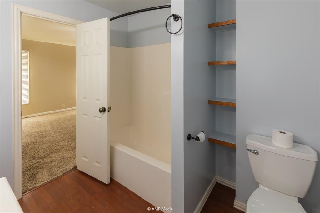 451 Northwest Ave F Hamlin, TX 79520 - Photo 20 of 29 a bathroom with a toilet and a shower