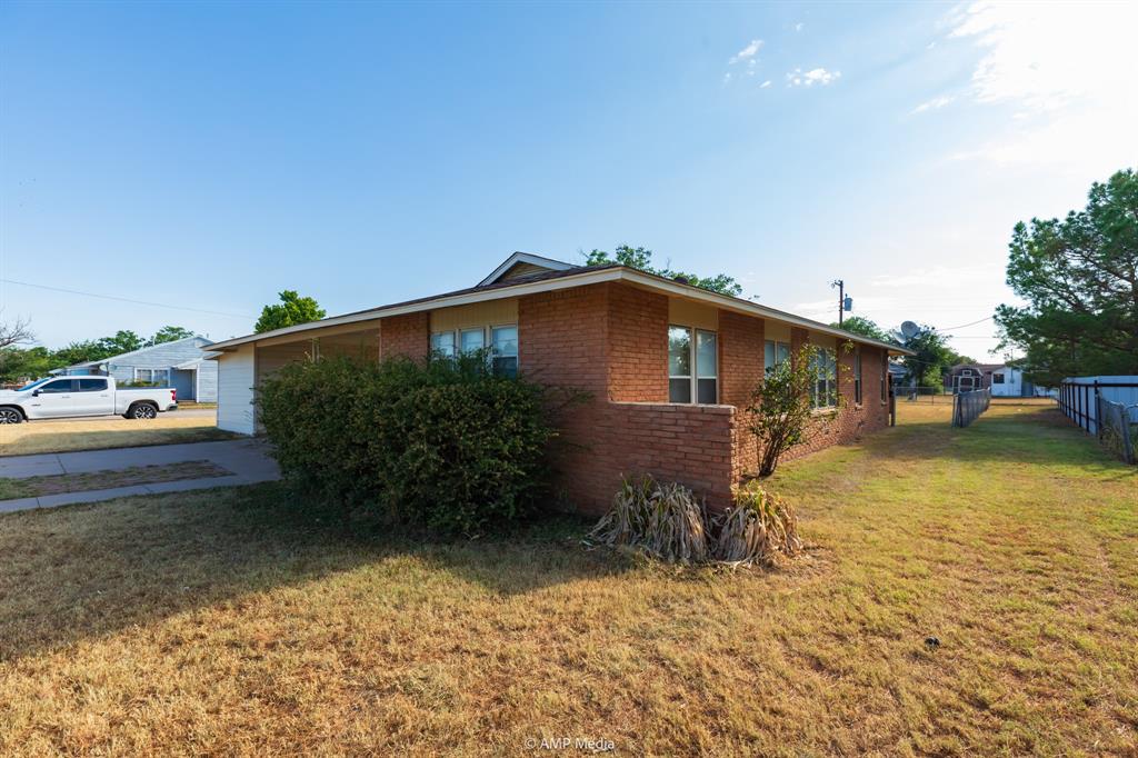451 Northwest Ave F Hamlin, TX 79520 - Photo 2 of 29 a backyard of a house with barbeque oven fire pit table and chairs